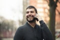 Handsome young man talking on his phone in an urban area Royalty Free Stock Photo