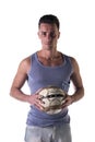 Handsome young man in tanktop holding soccer ball