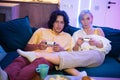 Handsome young man teaching how to play the video games to his girlfriend, on the couch, concept about home Royalty Free Stock Photo