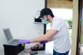 handsome young man telephone operator worker fixing internet issue connexion at client house with surgical mask and gloves COVID19