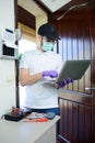 Handsome young man telephone operator worker fixing internet issue connexion at client house with surgical mask and gloves COVID19