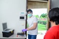 Handsome young man telephone operator worker fixing internet issue connexion at client house with surgical mask and gloves COVID19