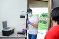 Handsome young man telephone operator worker fixing internet issue connexion at client house with surgical mask and gloves COVID19