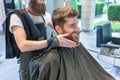 Handsome young man thinking of a different shape for his beard