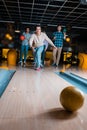 Handsome young man throwing bowling ball Royalty Free Stock Photo