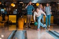 Handsome young man throwing bowling ball Royalty Free Stock Photo