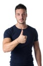 Handsome young man with thumb up doing OK sign Royalty Free Stock Photo