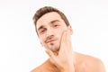 Handsome young man touching his face after shave Royalty Free Stock Photo