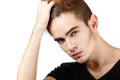 Handsome young man touching his hair, portrait of guy looki Royalty Free Stock Photo