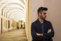 Handsome young man under cloisters in Italian city at night Royalty Free Stock Photo