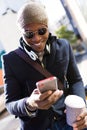 Handsome young man using his mobile phone in the street. Royalty Free Stock Photo