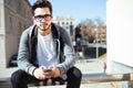 Handsome young man using his mobile phone in the street. Royalty Free Stock Photo