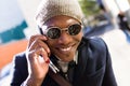 Handsome young man using his mobile phone in the street. Royalty Free Stock Photo