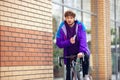 Handsome young man using mobile phone and headphones while riding his bicycle Royalty Free Stock Photo