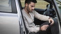 Young Man using mobile phone sitting in car Royalty Free Stock Photo