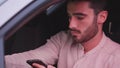 Young Man using mobile phone sitting in car Royalty Free Stock Photo