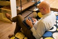 Handsome young man using phone while sitting on couch at home. free time activities