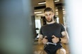 Young man using seated row machine in the gym