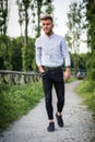 Handsome young man walking in city park Royalty Free Stock Photo