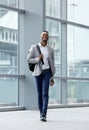 Handsome young man walking at station with bag Royalty Free Stock Photo