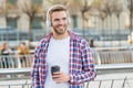 Handsome young man wear headphones and smiling while listening music and drinking coffee, morning inspiration. Royalty Free Stock Photo