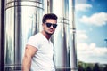 Handsome young man in white t-shirt outdoor in city setting Royalty Free Stock Photo