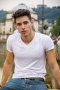 Handsome young man in white t-shirt outdoor in Royalty Free Stock Photo