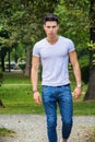 Handsome young man in white t-shirt outdoor in Royalty Free Stock Photo