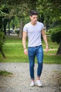 Handsome young man in white t-shirt outdoor in Royalty Free Stock Photo