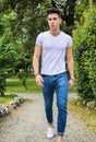 Handsome young man in white t-shirt outdoor in Royalty Free Stock Photo