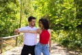 Handsome young man and woman dancing bachata and salsa in the park. The couple dance passionately surrounded by greenery. Dancing Royalty Free Stock Photo