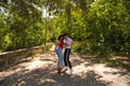 Handsome young man and woman dancing bachata and salsa in the park. The couple dance passionately surrounded by greenery. Dancing Royalty Free Stock Photo