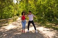 Handsome young man and woman dancing bachata and salsa in the park. The couple dance passionately surrounded by greenery. Dancing Royalty Free Stock Photo