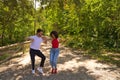 Handsome young man and woman dancing bachata and salsa in the park. The couple dance passionately surrounded by greenery. Dancing Royalty Free Stock Photo