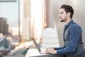 Charming young man working on his laptop in the city Royalty Free Stock Photo