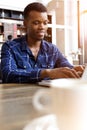 Handsome young man working on laptop at cafe Royalty Free Stock Photo