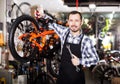 Man working on master mechanic assembling bicycle equipment Royalty Free Stock Photo