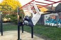 Handsome young man working out his abs while hanging on the horizontal ladder, side abs Royalty Free Stock Photo