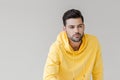 handsome young man in yellow hoodie looking away Royalty Free Stock Photo