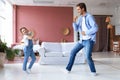 Handsome young man dancing at home with his little cute daugther Royalty Free Stock Photo