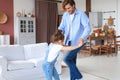 Handsome young man dancing at home with his little cute daugther Royalty Free Stock Photo