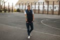 Handsome young man with glasses in vintage jeans style walking