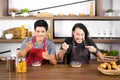 Handsome young men having breakfast,one man hand sign thumb up and the other finger point to spoon in modern dining room apartment Royalty Free Stock Photo