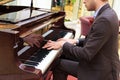 Handsome young men playing piano at the restaurante Royalty Free Stock Photo