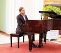 Handsome young men playing piano at the restaurante Royalty Free Stock Photo