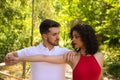 Handsome young man and woman dancing bachata and salsa in the park. The couple dance passionately surrounded by greenery. Dancing Royalty Free Stock Photo