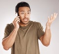 Handsome young mixed race man looking irritated, aggravated or agitated while using his phone in studio isolated against