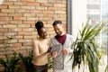 Young multiethnic business couple with digital tablet standing and discussing in the modern office Royalty Free Stock Photo