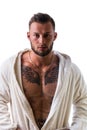 Handsome muscular young man wearing white bathrobe, isolated Royalty Free Stock Photo