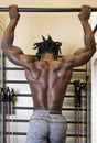 Bodybuilder Doing Pull-ups in the Gym Royalty Free Stock Photo